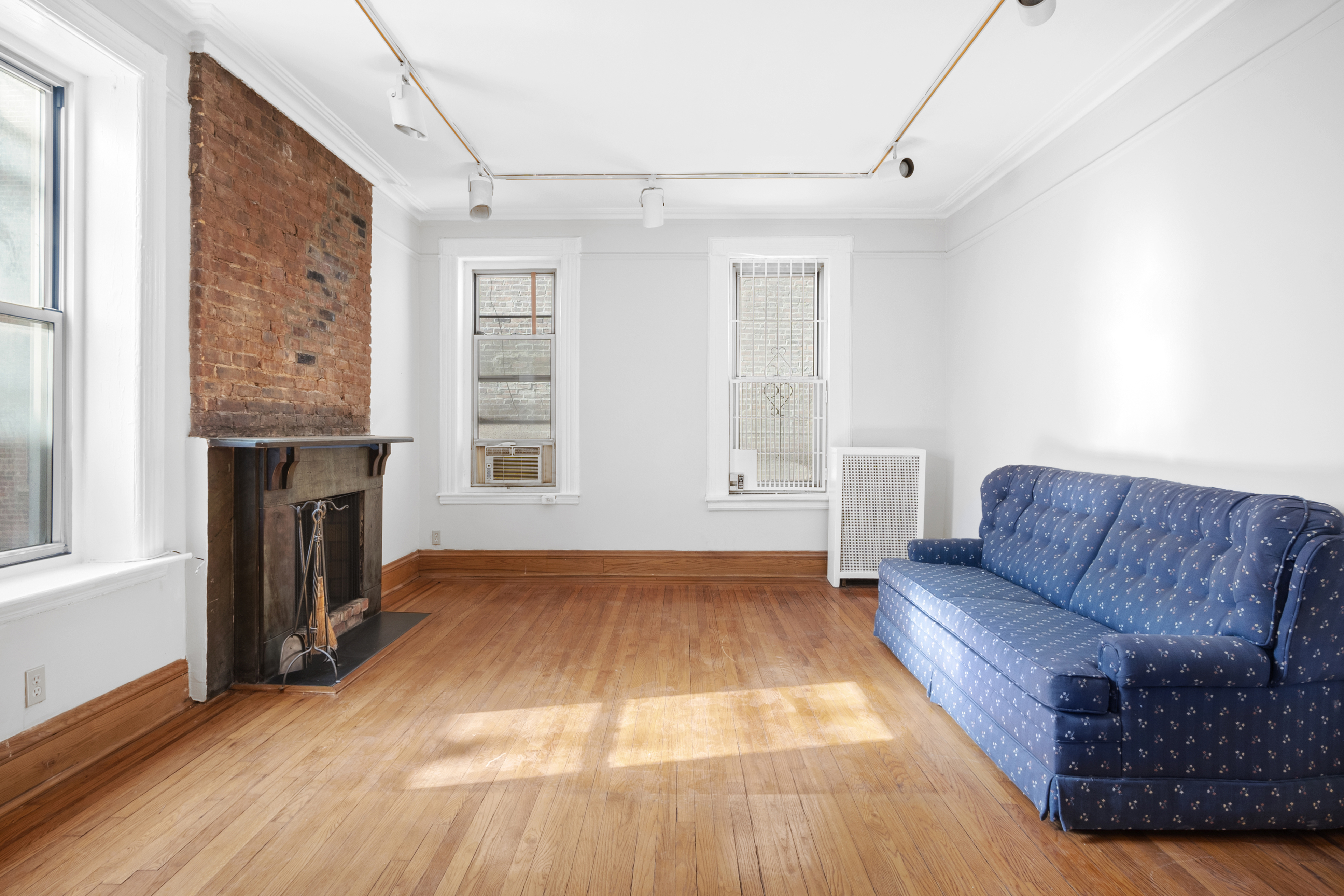 306 West 4th Street, Unit B1B2 Manhattan, NY 10014 - Photo 7 of 9 a living room with furniture and a fireplace