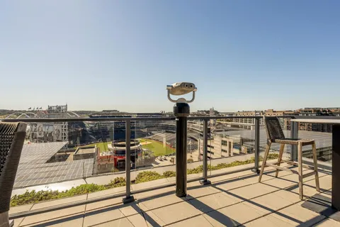 a view of a roof deck with furniture