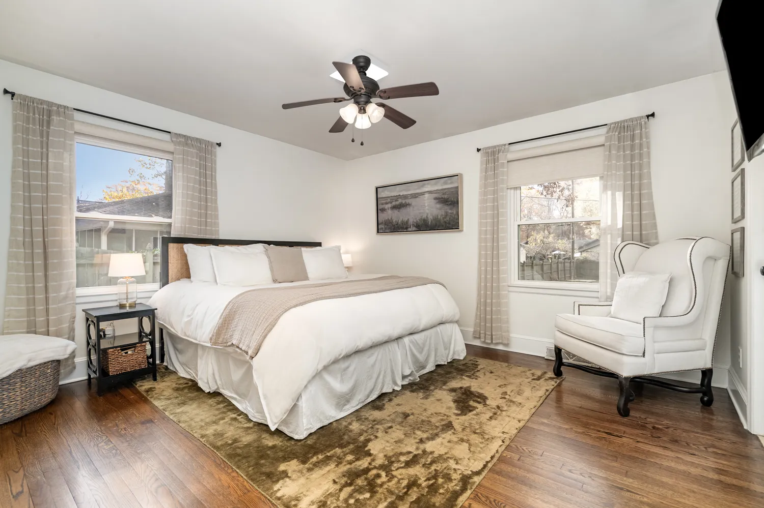 a bedroom with a bed and a large window