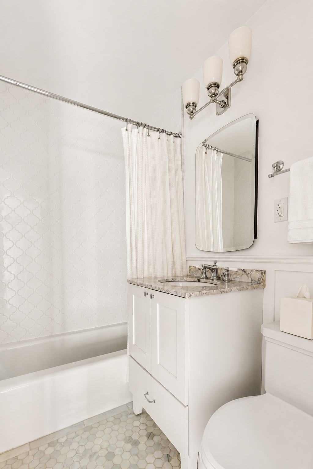 400 East 85th Street, Unit 4L Manhattan, NY 10028 - Photo 6 of 12 a bathroom with a sink a mirror and a toilet