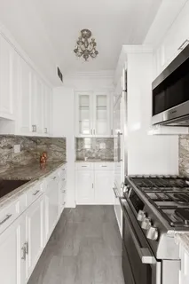 a kitchen with granite countertop a stove and a sink