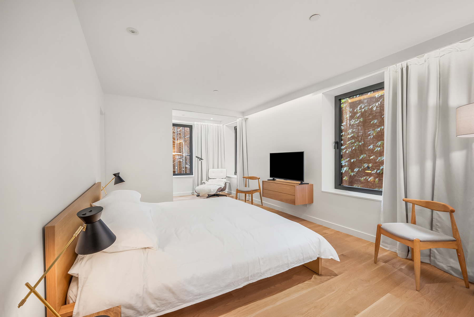 479 Washington Street, Unit 4 Manhattan, NY 10013 - Photo 5 of 8 a bedroom with a bed and a chair