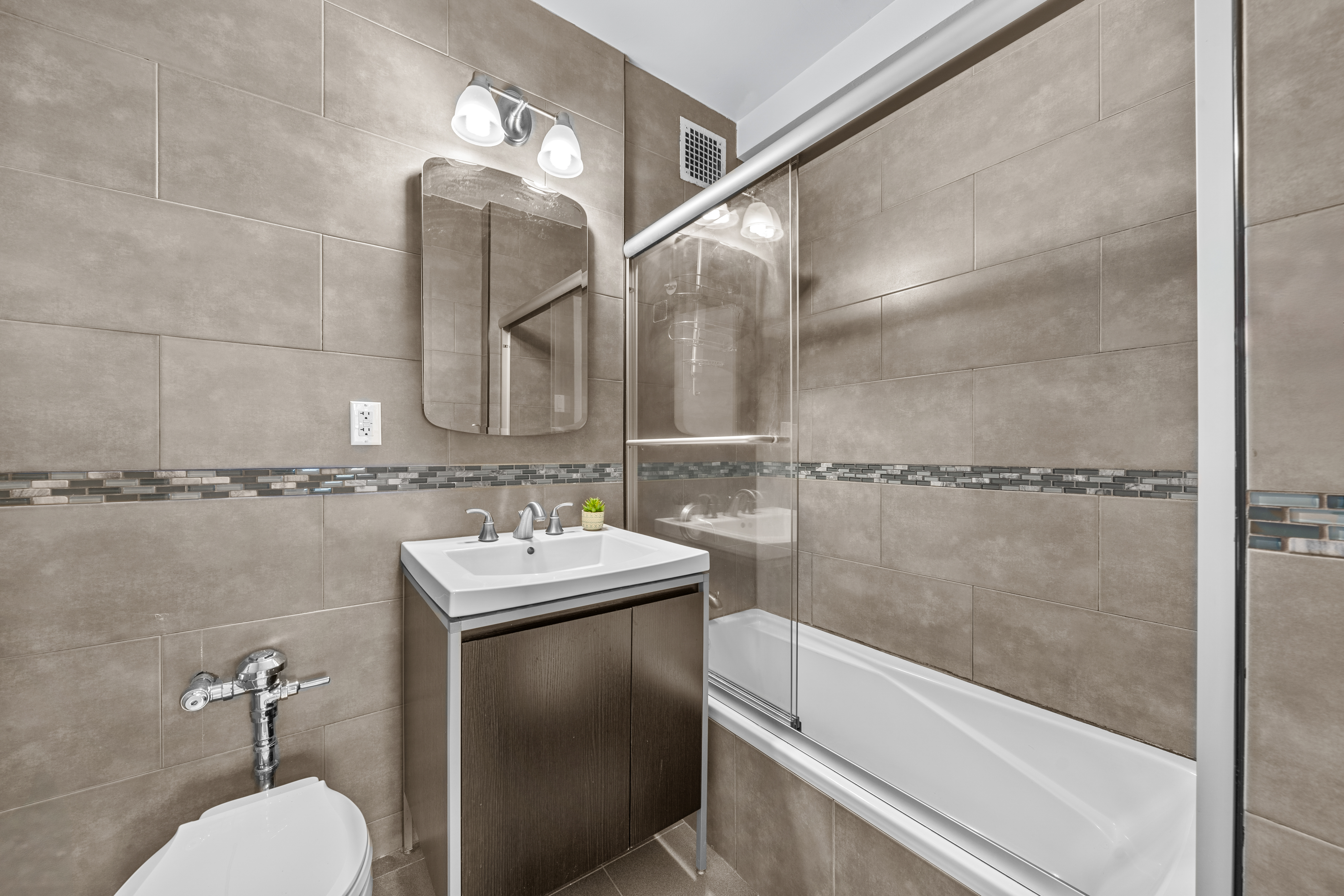 71-36 110th Street, Unit PH7E Queens, NY 11375 - Photo 14 of 16 a bathroom with a sink toilet and shower