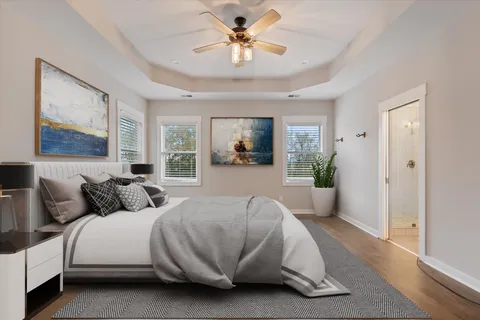 a bedroom with a bed and a chandelier