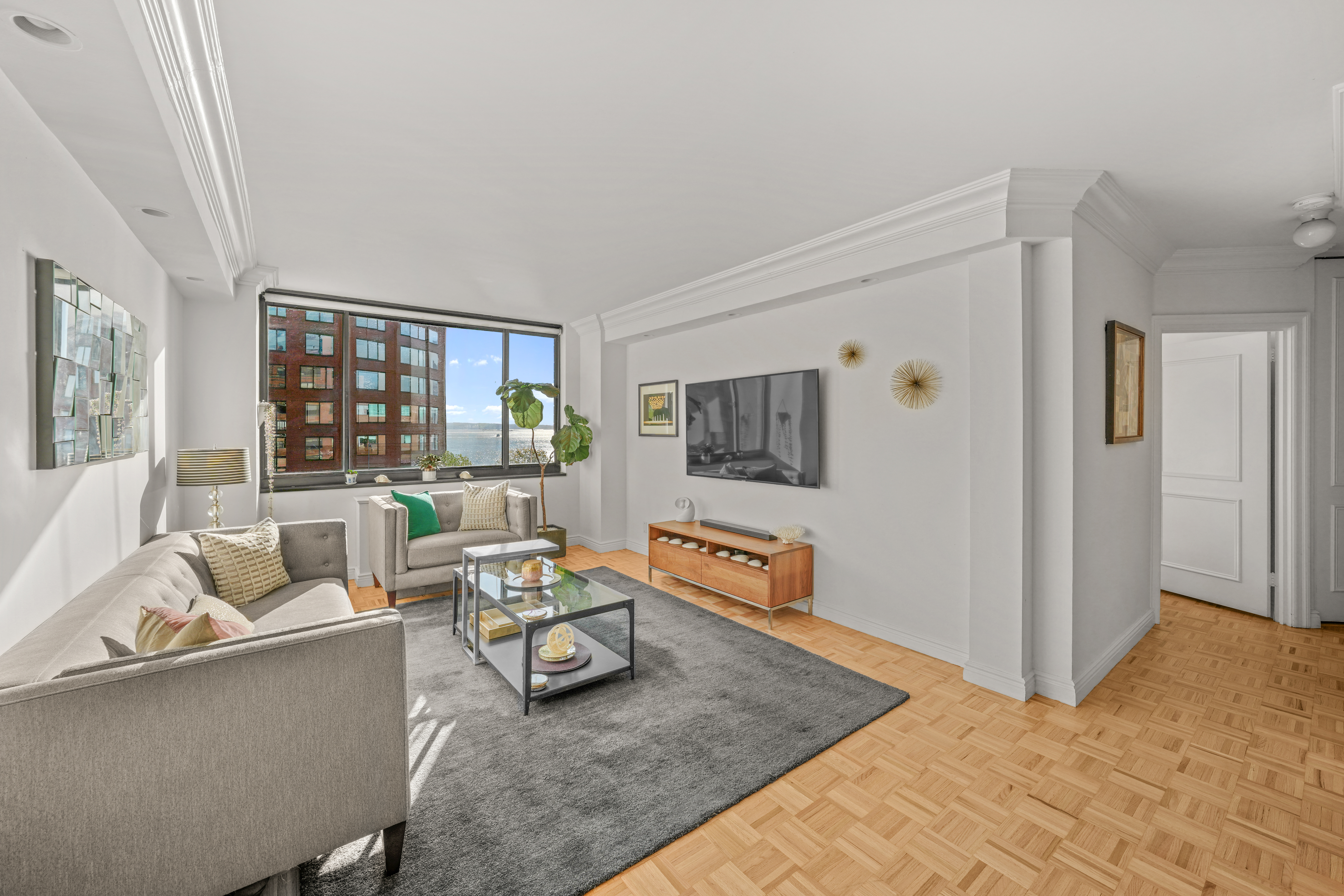 377 Rector Place, Unit 7K Manhattan, NY 10280 - Photo 2 of 11 a living room with furniture and a table