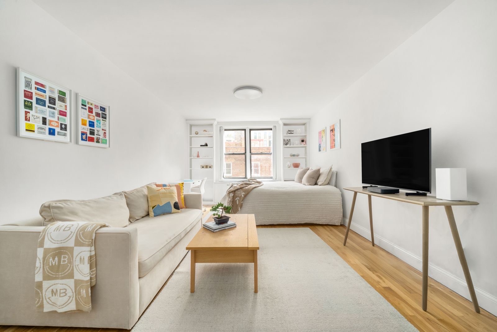 25 West 13th Street, Unit 6ON Manhattan, NY 10011 - Photo 2 of 7 a living room with furniture and a flat screen tv