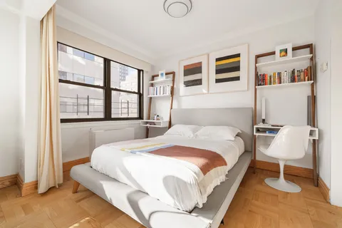 a bedroom with a large bed and a window