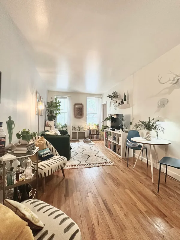 a living room with furniture and a wooden floor