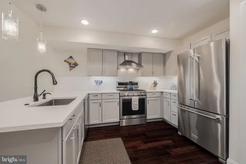 a kitchen with a sink stainless steel appliances and cabinets