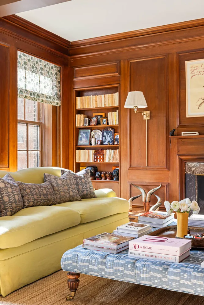 a living room with fireplace furniture and a large window