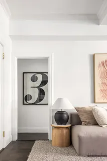 a living room with furniture and wall painting