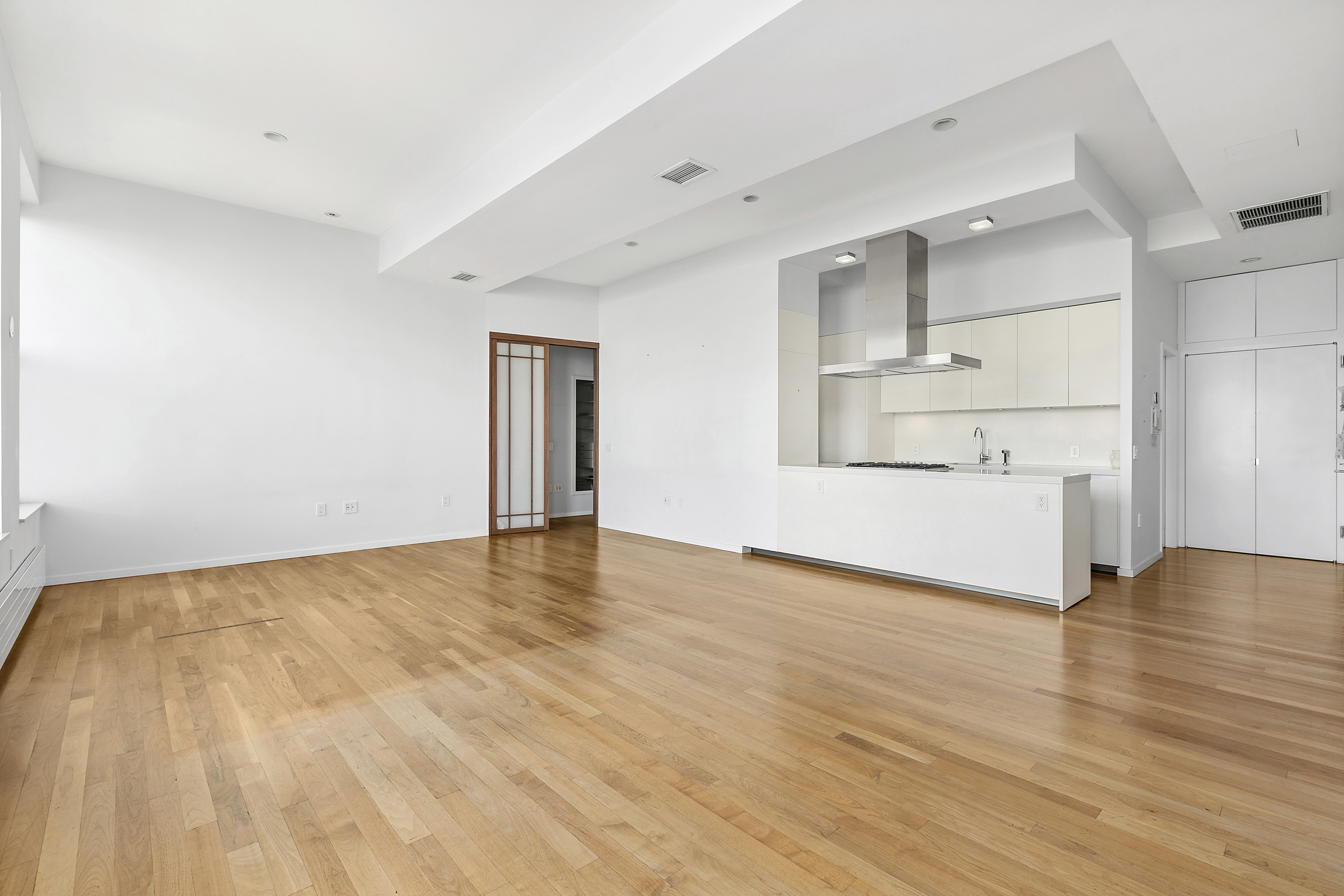 175 East Broadway, Unit 7A Manhattan, NY 10002 - Photo 6 of 9 a view of empty room with wooden floor and window