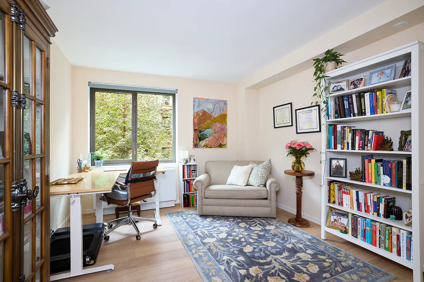 a living room with furniture and a book shelf