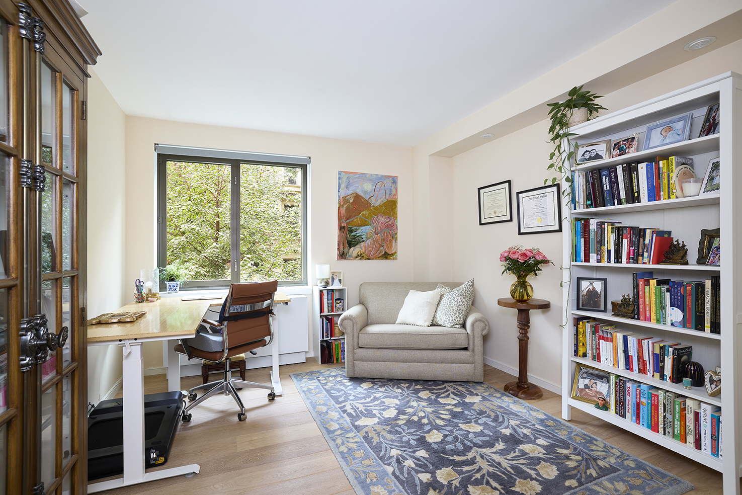 101 West 87th Street, Unit 205 Manhattan, NY 10024 - Photo 6 of 14 a living room with furniture and a book shelf