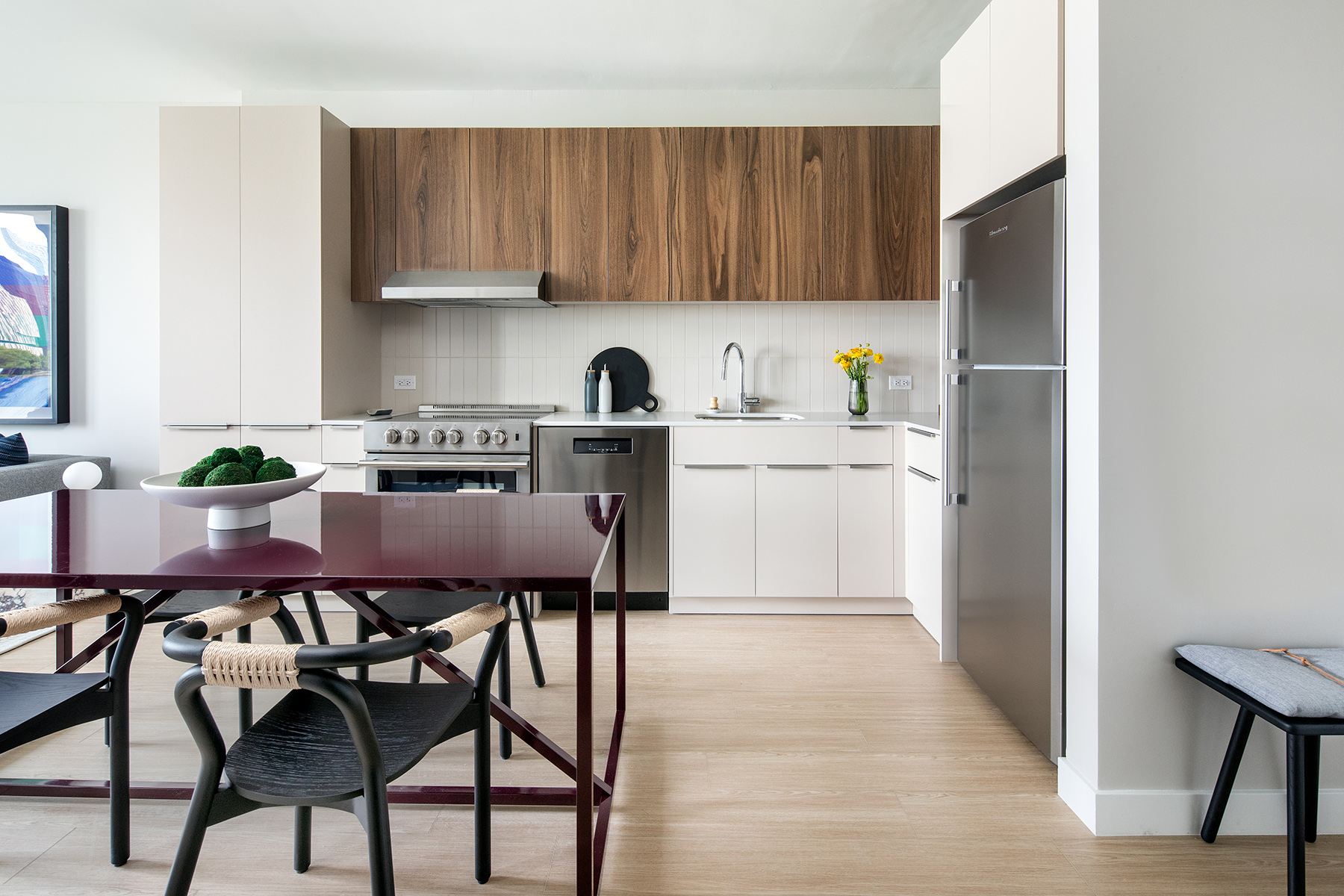 30-77 Vernon Boulevard, Unit 409E Queens, NY 11102 - Photo 2 of 21 a kitchen with stainless steel appliances granite countertop a table chairs sink and cabinets