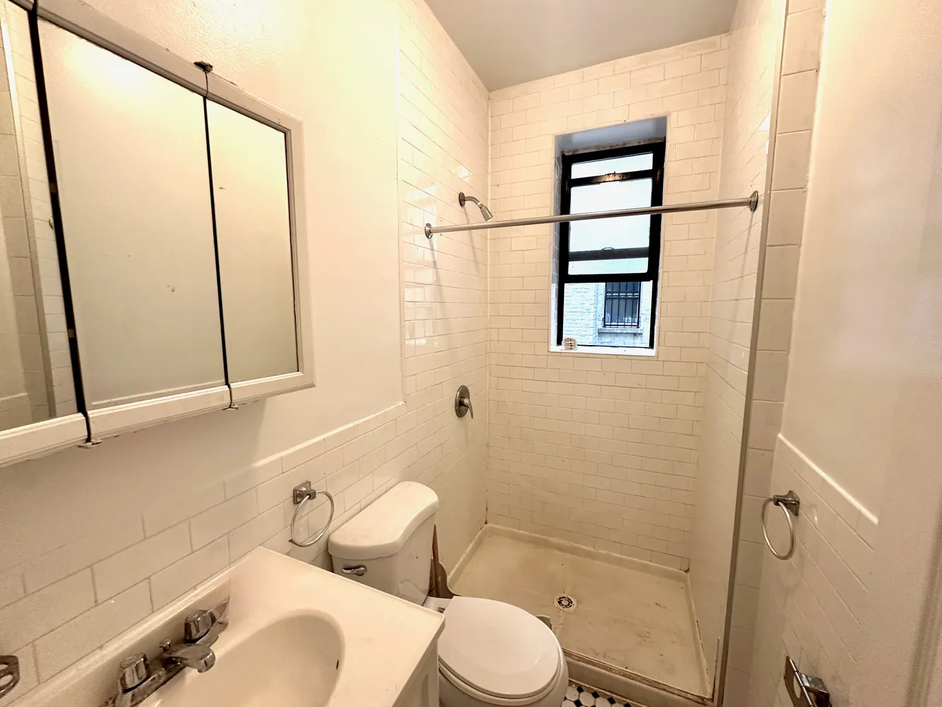a bathroom with a toilet sink and a shower