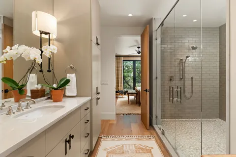 a white toilet sitting next to a bathroom sink and tub
