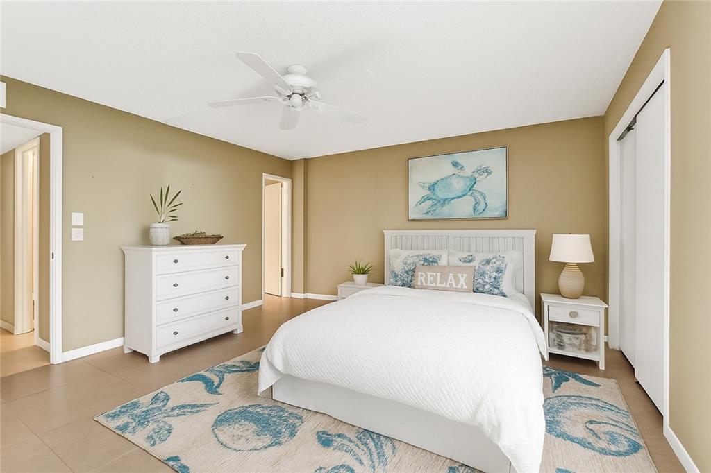 4601 Highway A1a, Unit 102 Vero Beach, FL 32963 - Photo 11 of 29 a bedroom with a bed and a dresser in it
