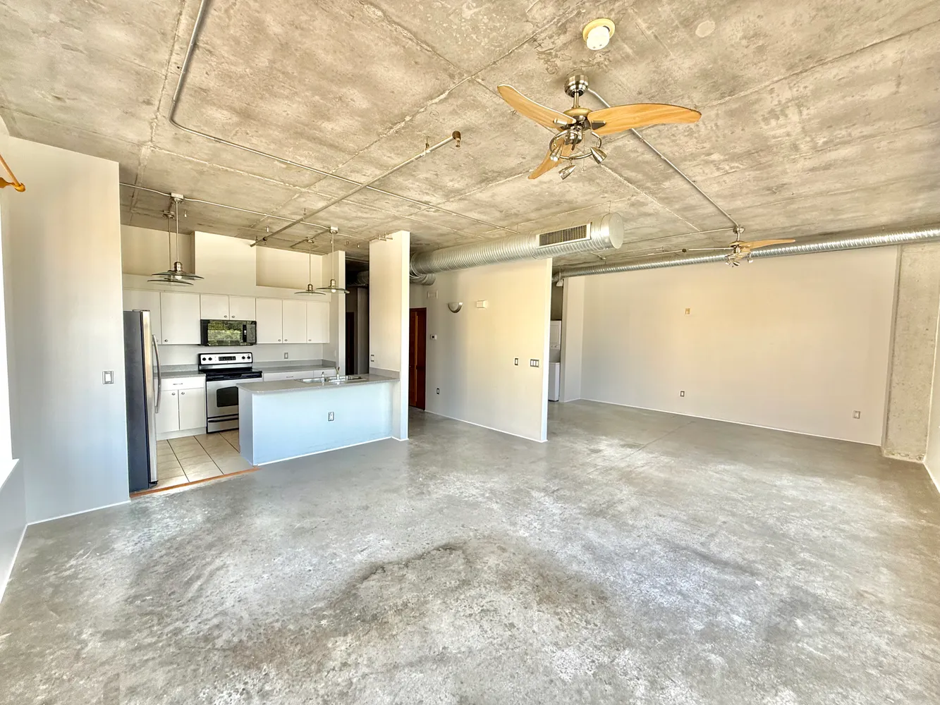 a view of a kitchen with a sink and a refrigerator