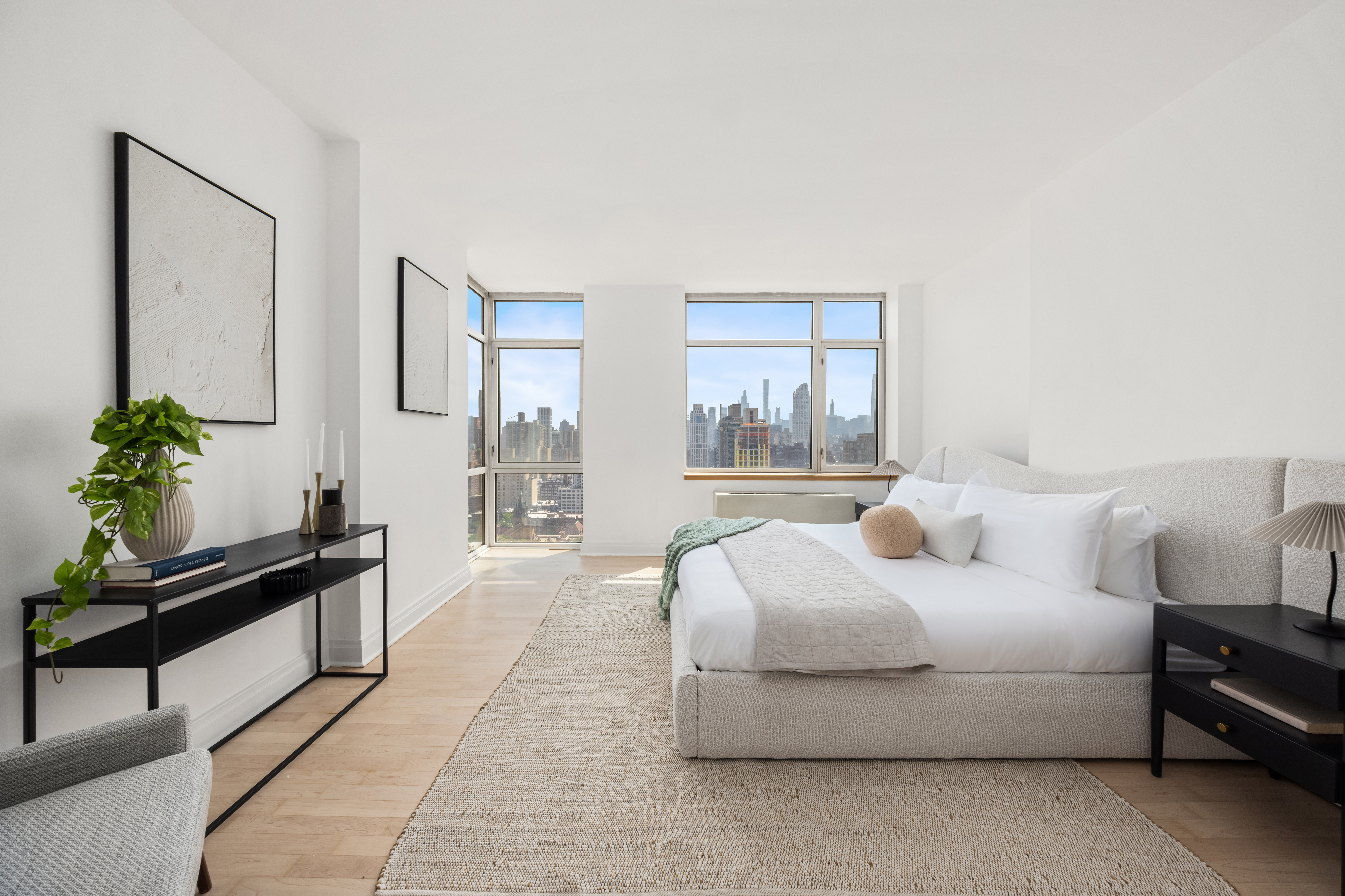 1760 2nd Avenue, Unit 30C Manhattan, NY 10128 - Photo 6 of 21 a bedroom with a bed lamp and a potted plant