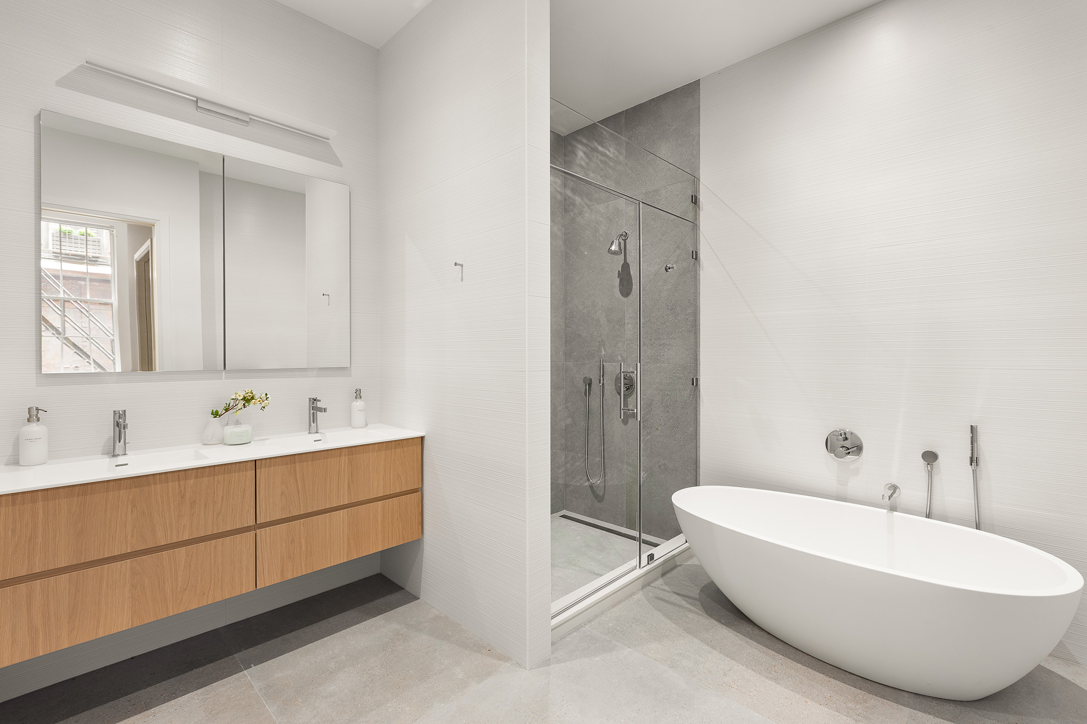 66 Reade Street, Unit TH Manhattan, NY 10007 - Photo 7 of 18 a bathroom with a tub sink and mirror