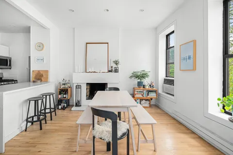 a dining room with furniture and wooden floor
