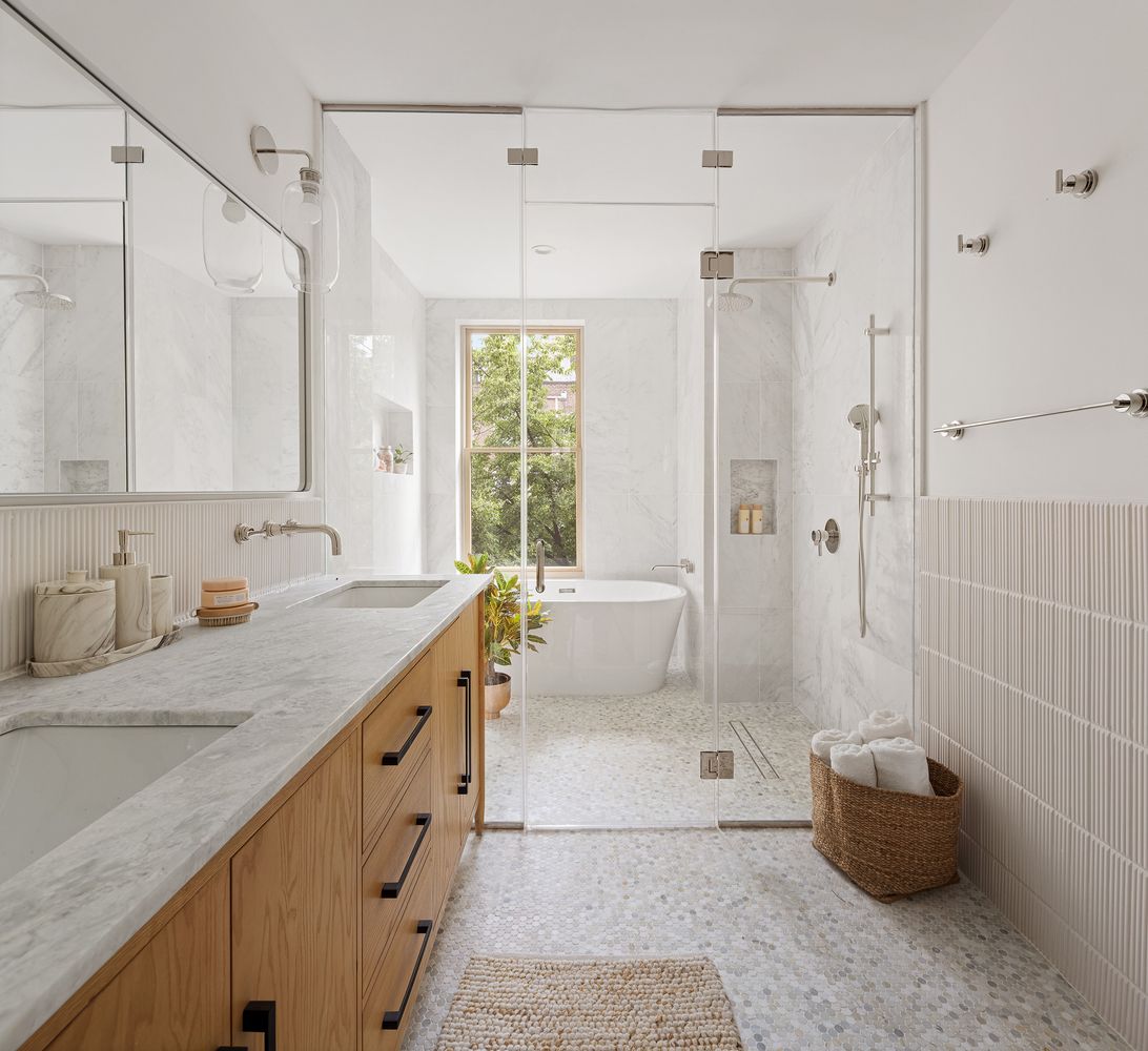a bathroom with a granite countertop sink a toilet a shower and a bathtub