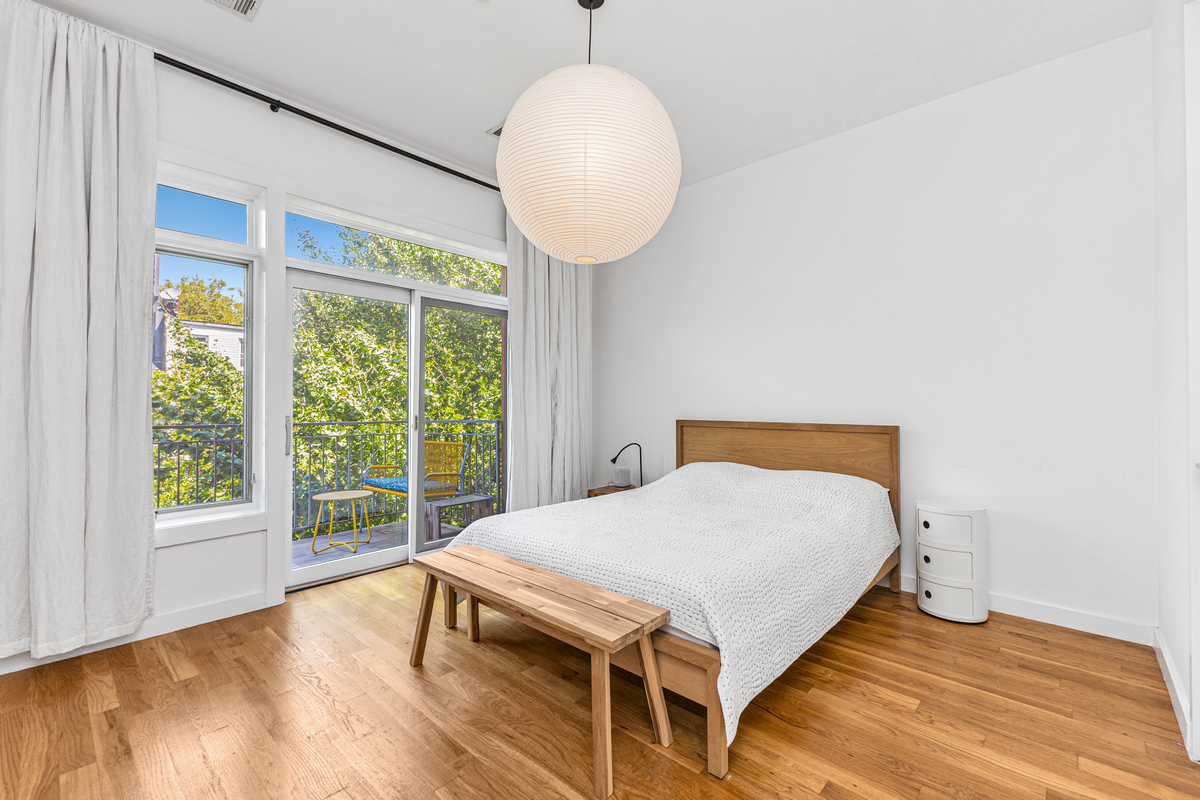 325 Greene Avenue, Unit 3B Brooklyn, NY 11238 - Photo 3 of 7 a bed sitting in a bedroom next to a window