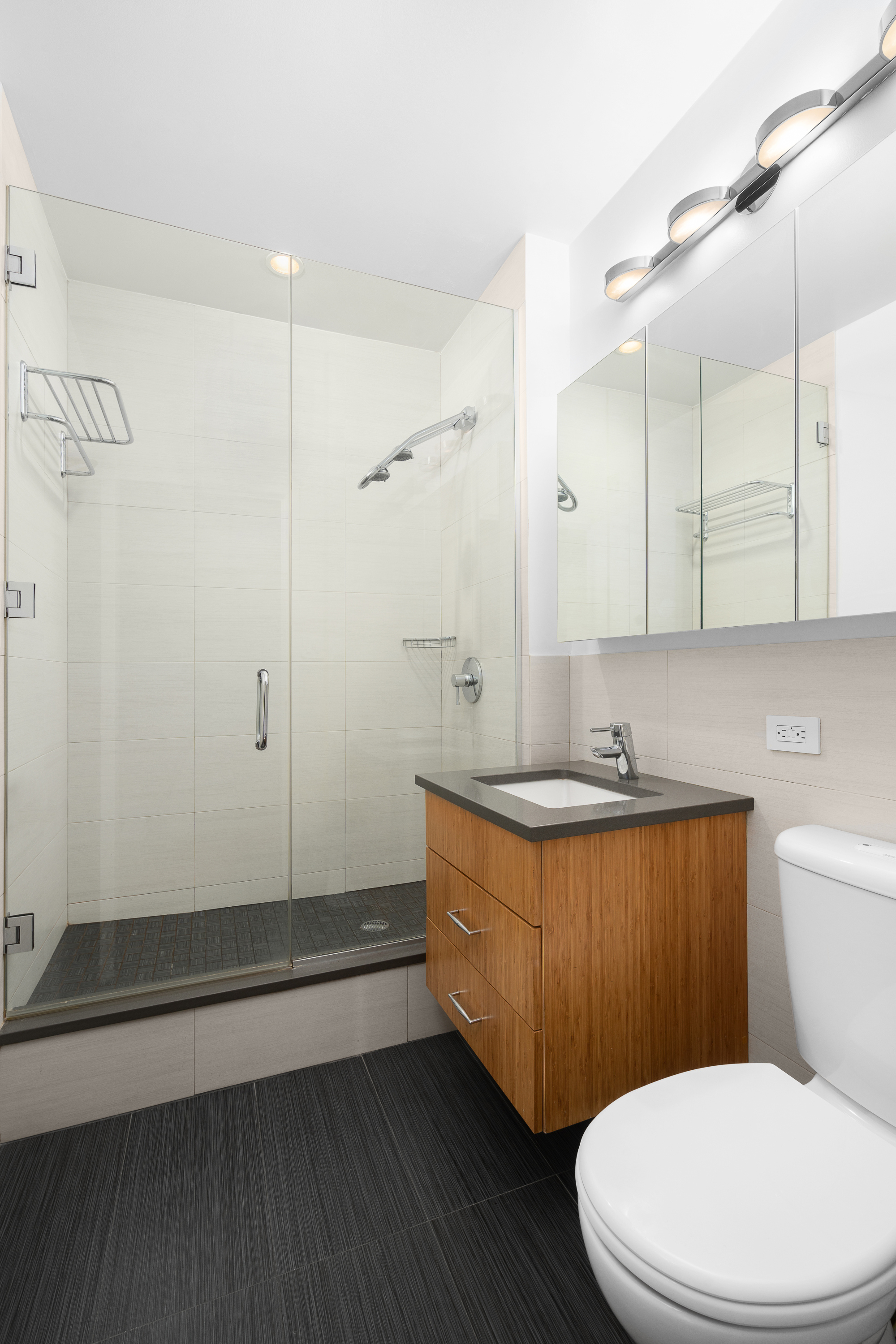 99 John Street, Unit 922 Manhattan, NY 10038 - Photo 8 of 14 a bathroom with a sink a toilet and shower