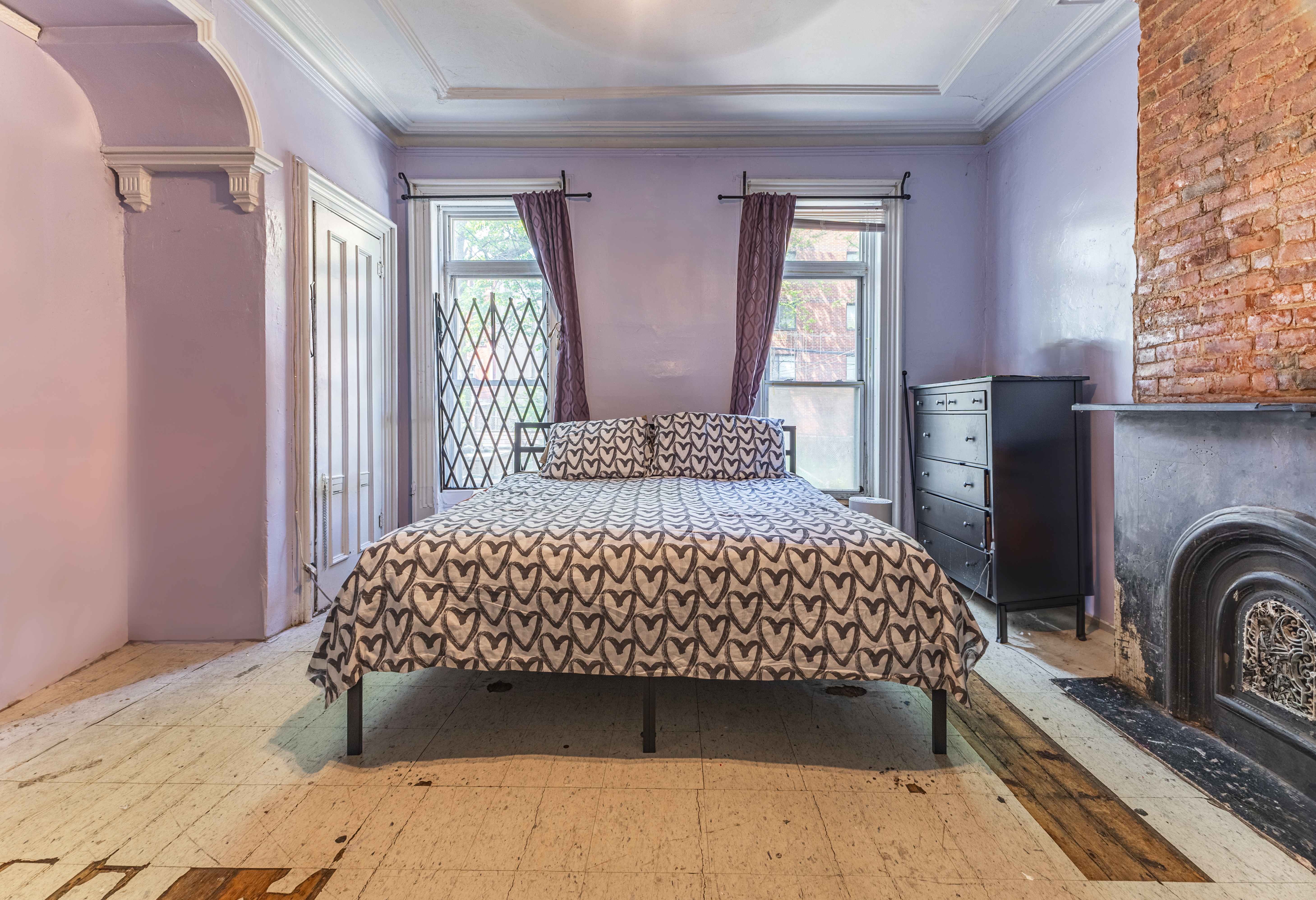 799 Willoughby Avenue Brooklyn, NY 11206 - Photo 4 of 12 a bedroom with a bed next to a window