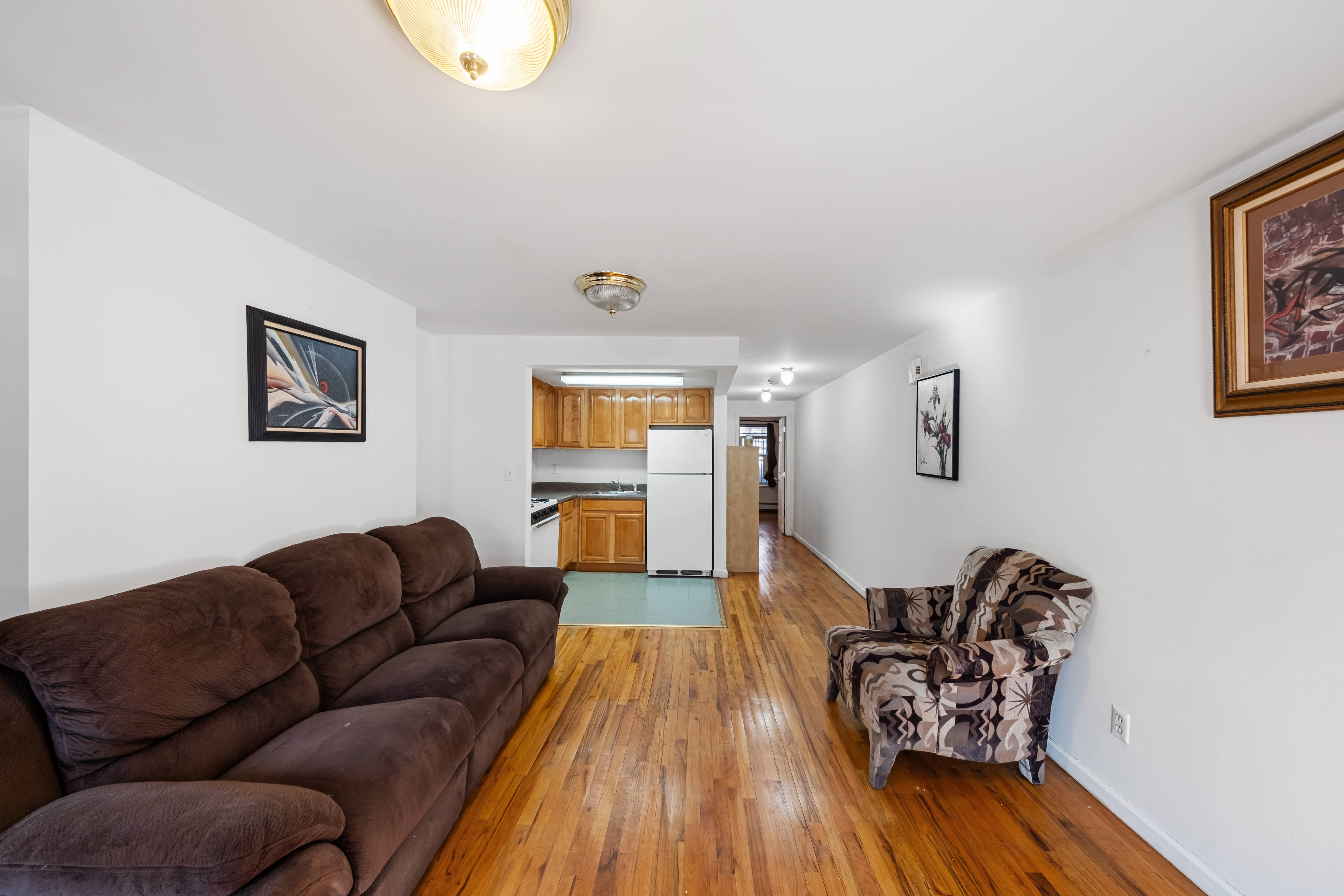 275 Van Buren Street Brooklyn, NY 11221 - Photo 16 of 33 a living room with furniture and a wooden floor