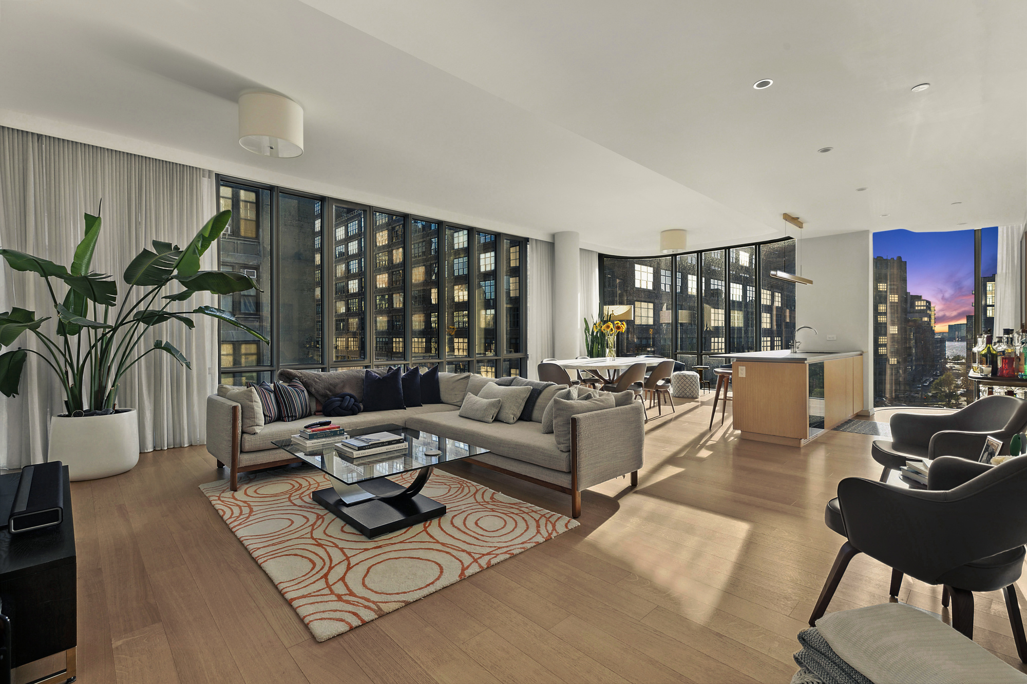 565 Broome Street, Unit S8C Manhattan, NY 10013 - Photo 4 of 24 a living room with furniture a rug potted plant and a large window