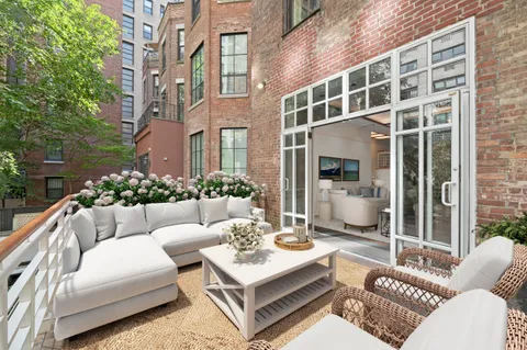 a view of a patio with couches chairs and a potted plant