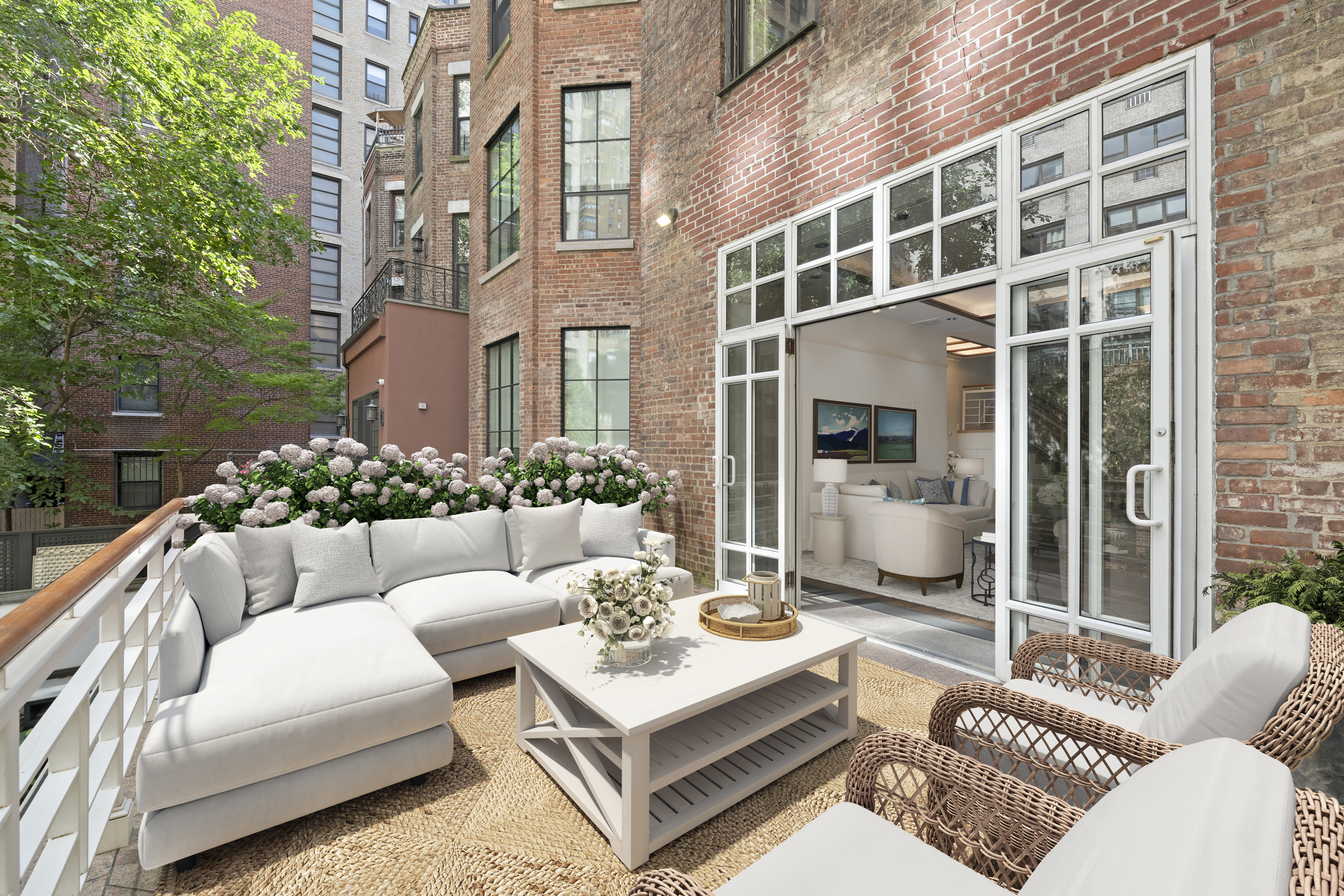 a view of a patio with couches chairs and a potted plant
