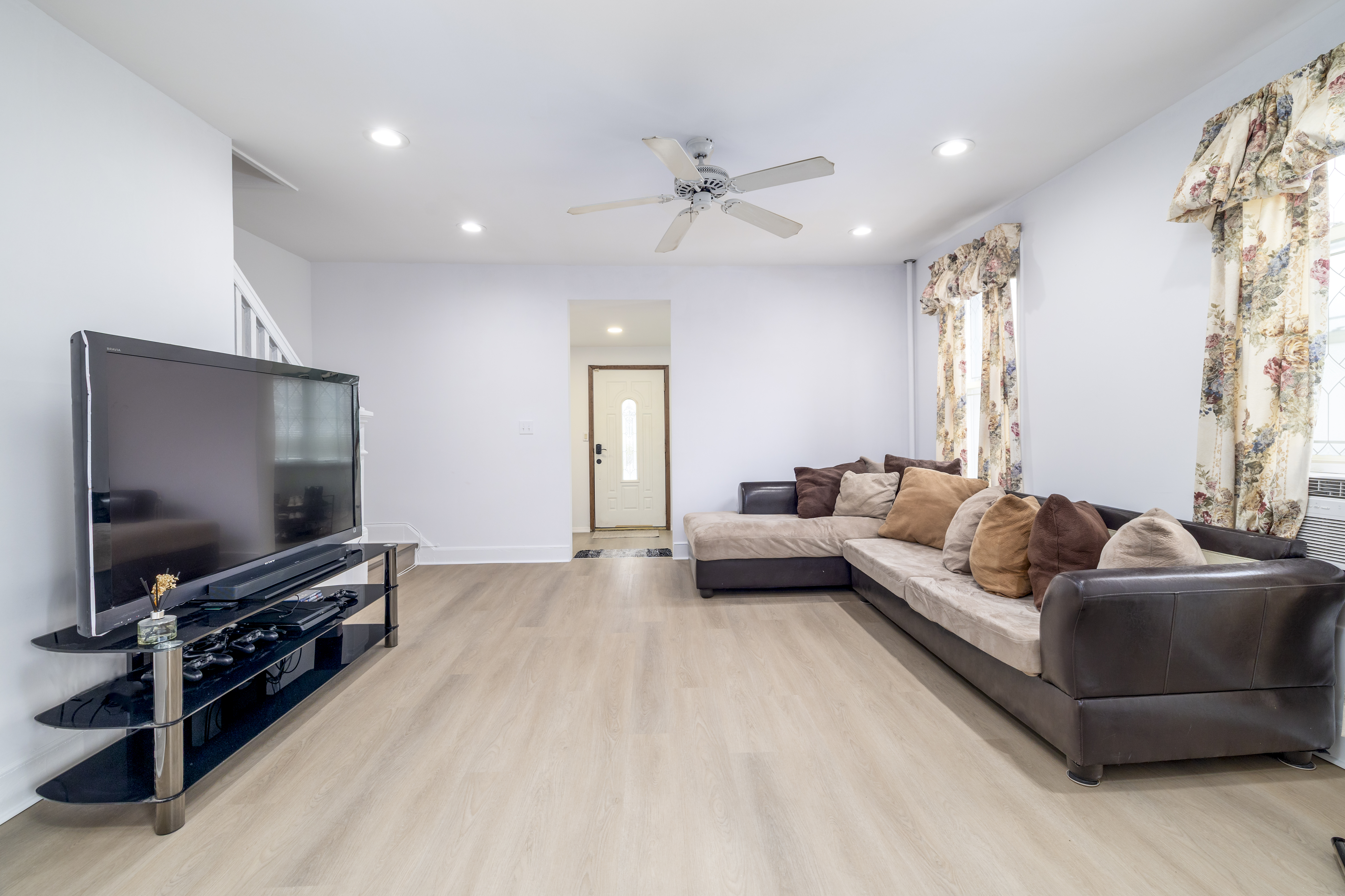 87-46 89th Street Queens, NY 11421 - Photo 4 of 25 a living room with furniture and a flat screen tv