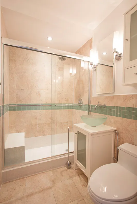 170 West 23rd Street, Unit 2F Manhattan, NY 10011 - Photo 4 of 10 a bathroom with a sink a toilet and shower