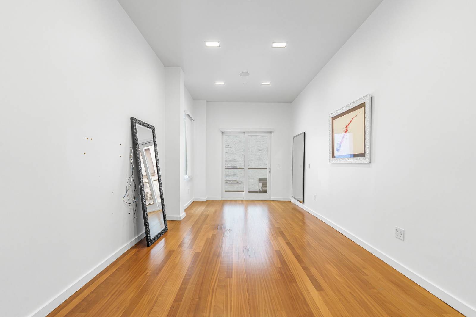 124 East 13th Street, Unit 3 Manhattan, NY 10003 - Photo 20 of 26 a view of empty room with wooden floor and window