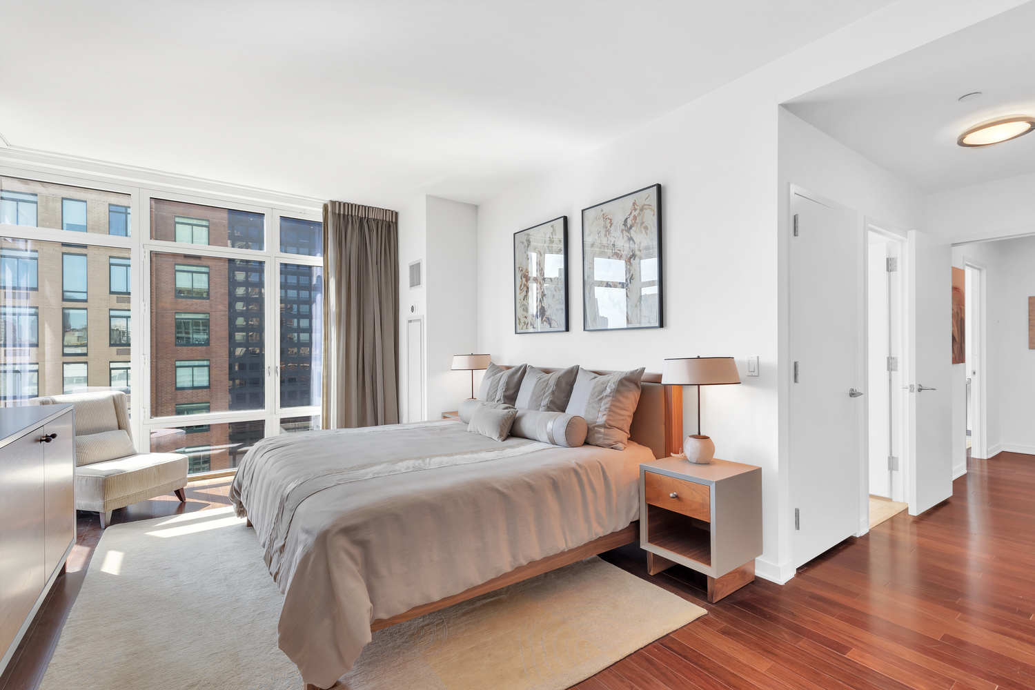 207 East 57th Street, Unit 25B Manhattan, NY 10022 - Photo 12 of 19 a bedroom with a large bed and a couch