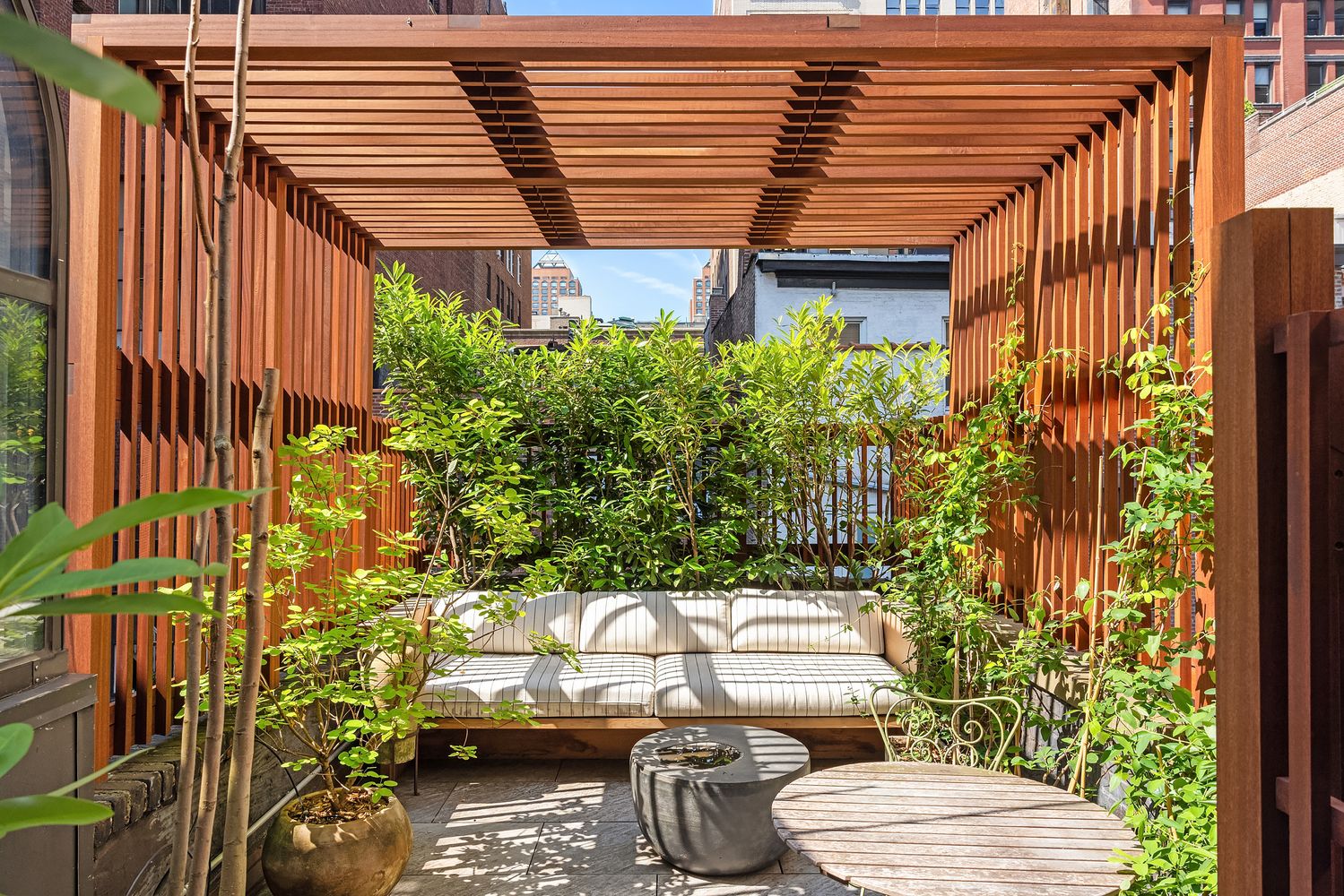 a view of a patio with table and chairs and potted plants