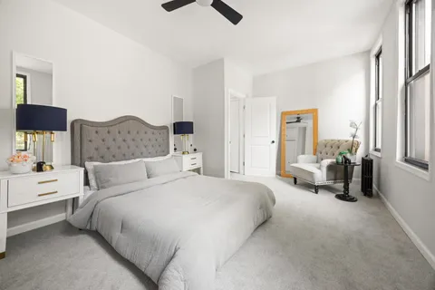 a bedroom with a bed and a large window