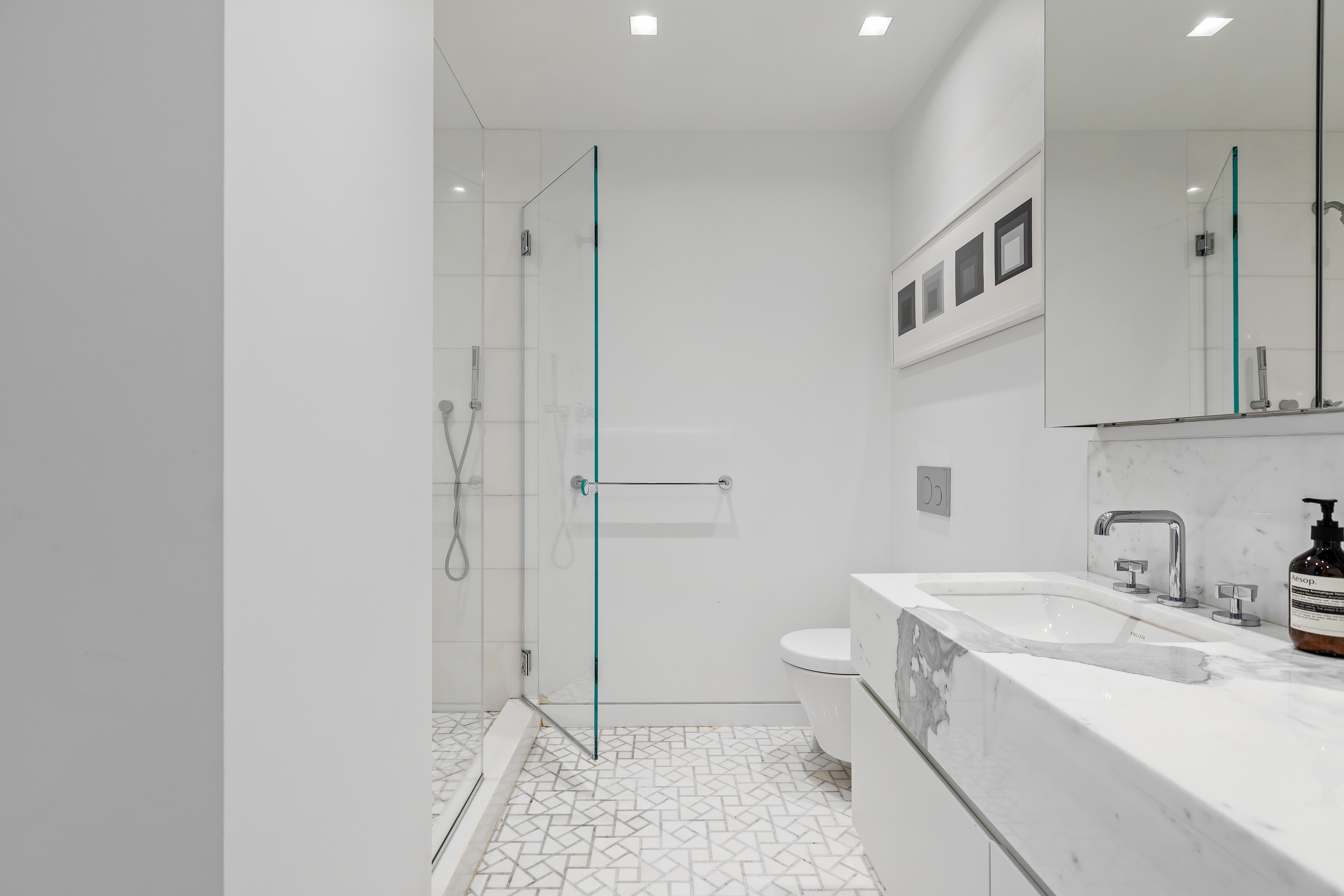 1 5th Avenue, Unit 16F Manhattan, NY 10003 - Photo 17 of 23 a bathroom with a sink a toilet and shower