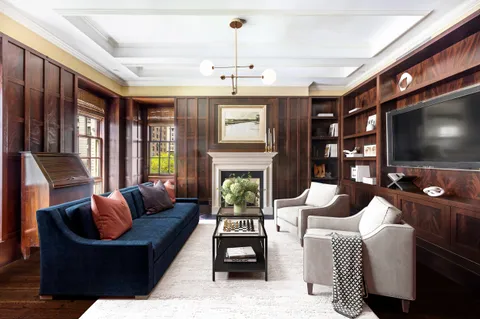 a living room with fireplace furniture and a flat screen tv
