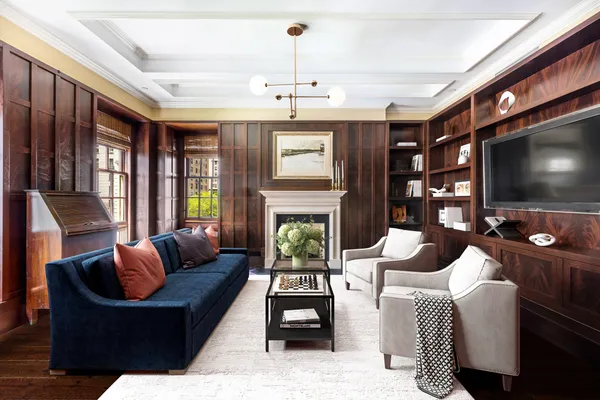 a living room with fireplace furniture and a flat screen tv