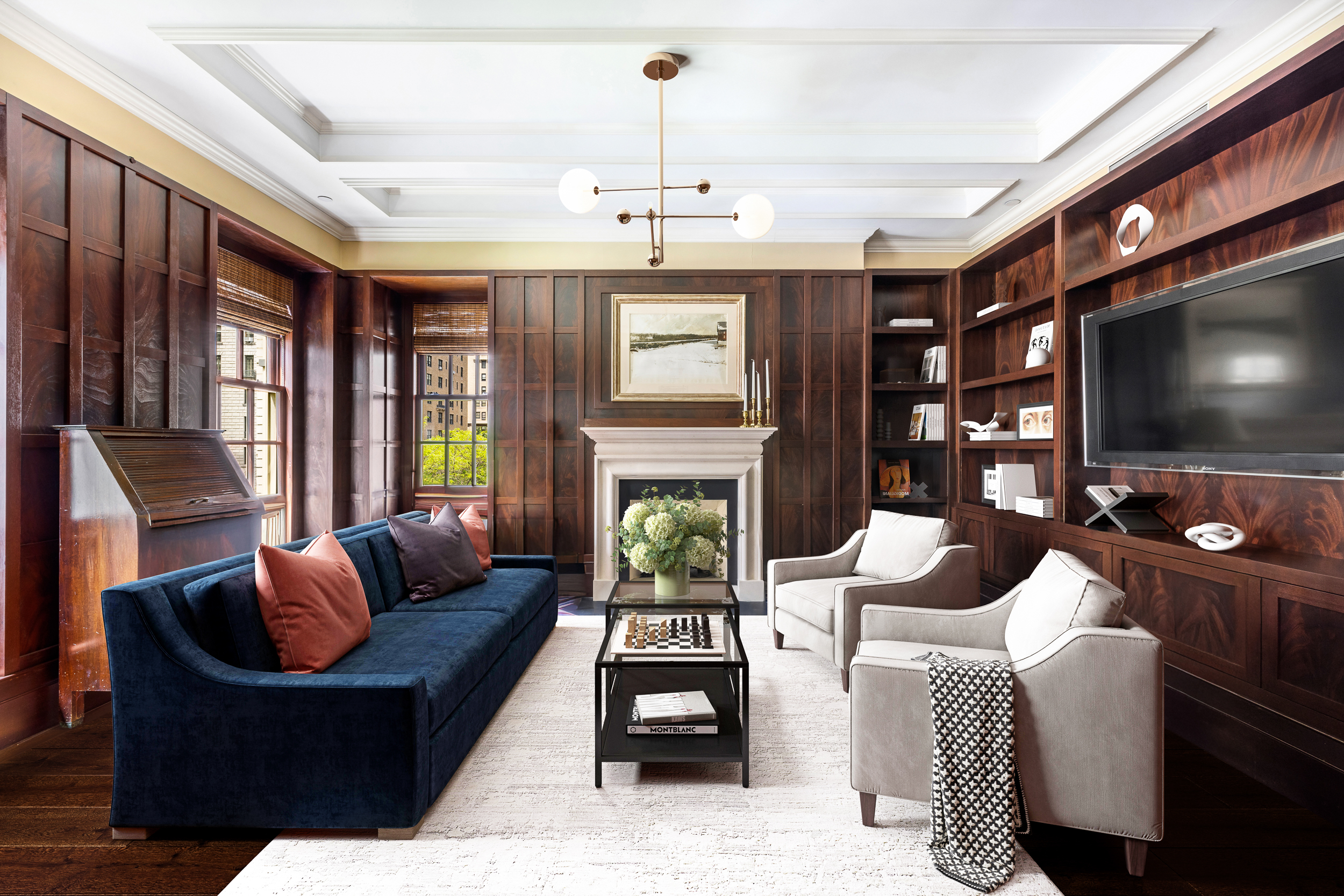 a living room with fireplace furniture and a flat screen tv