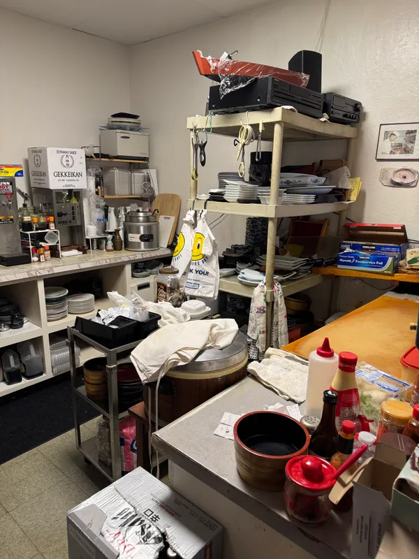 a room with furniture a flat screen tv and clock on the wall