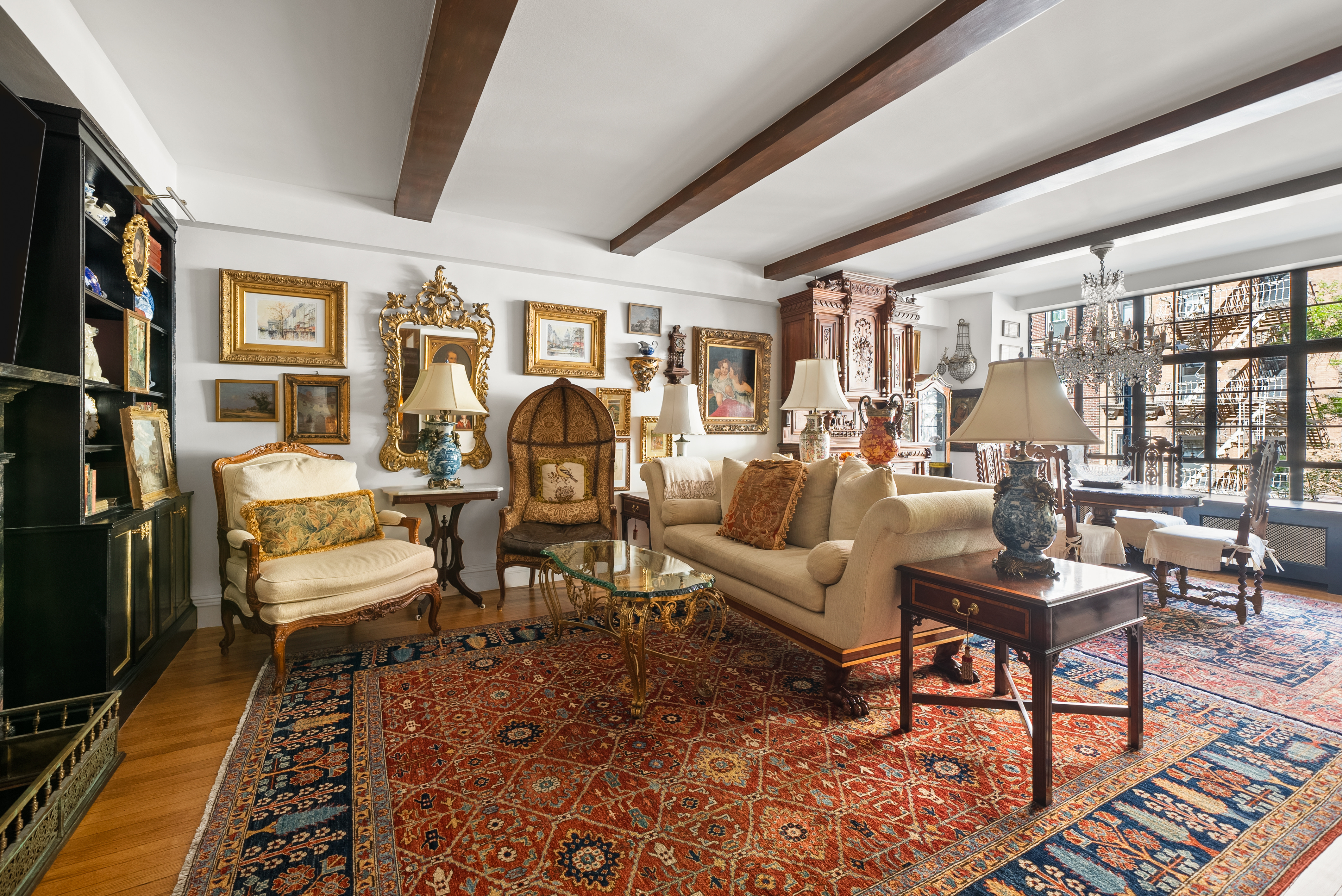 a living room with furniture and a floor to ceiling window