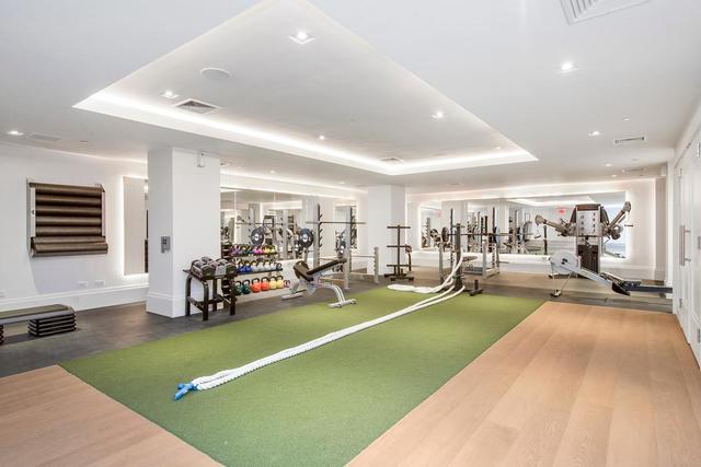 101 Wall Street, Unit 12C Manhattan, NY 10005 - Photo 13 of 18 a view of a room with gym equipment and a large window