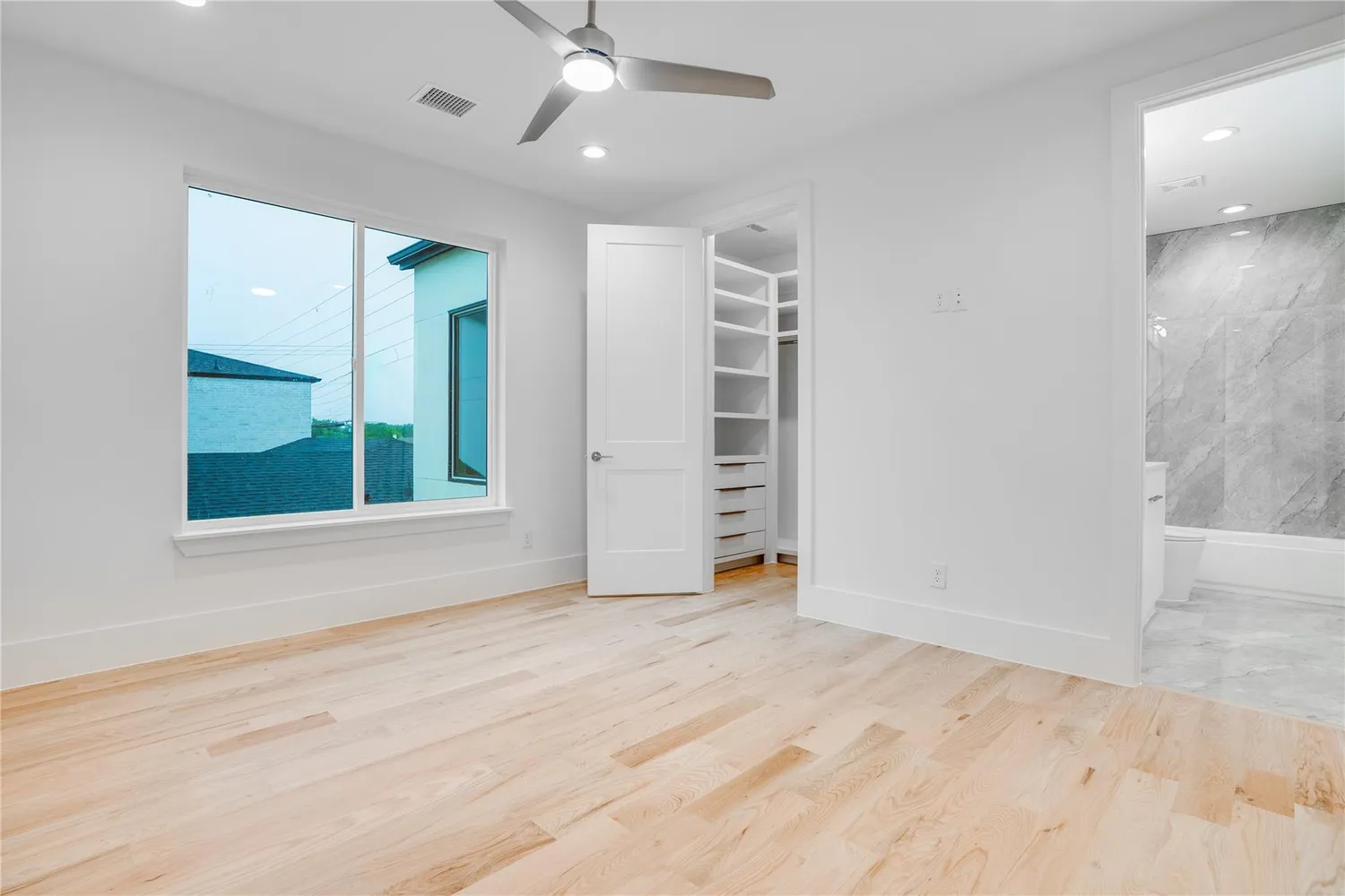 an empty room with windows and closet