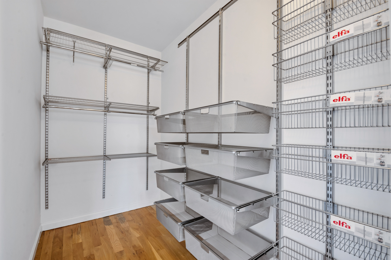 416 East 117th Street, Unit PH6 Manhattan, NY 10035 - Photo 14 of 18 a view of a room with racks on the wall