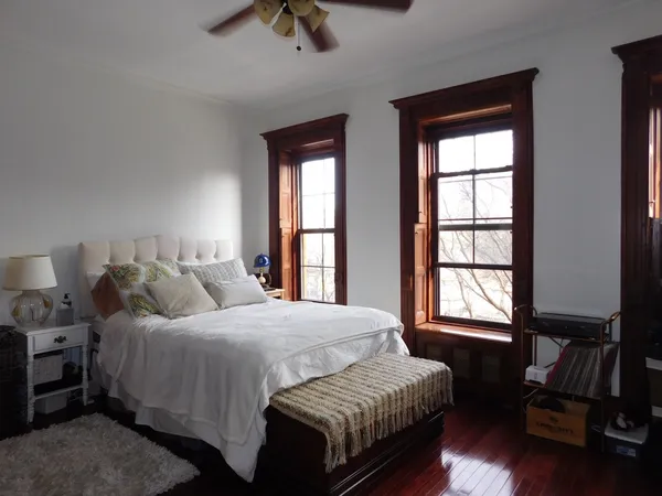 a bedroom with a bed and window